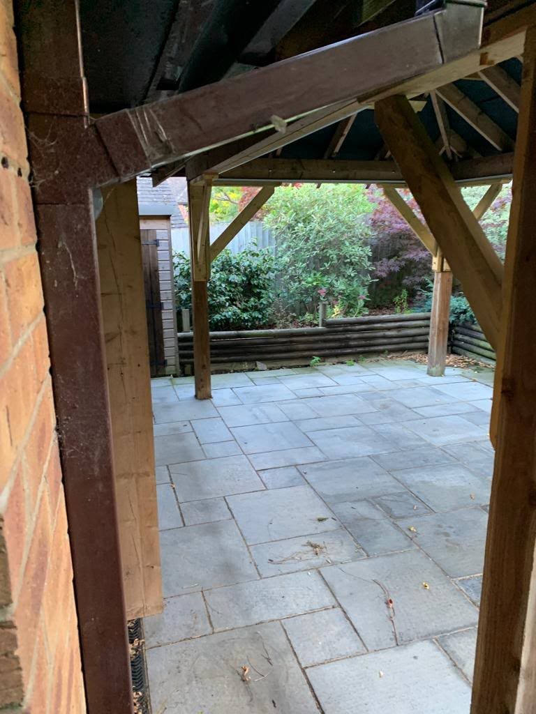 oak-framed covered porch with stone patio