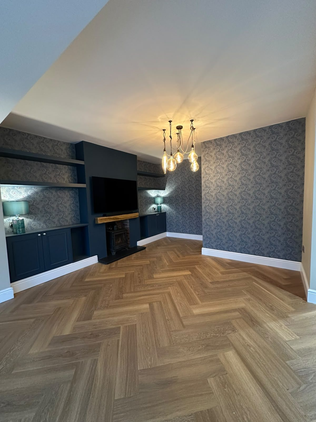 Fitted alcove cupboards and shelving with an oak mantel in Northampton