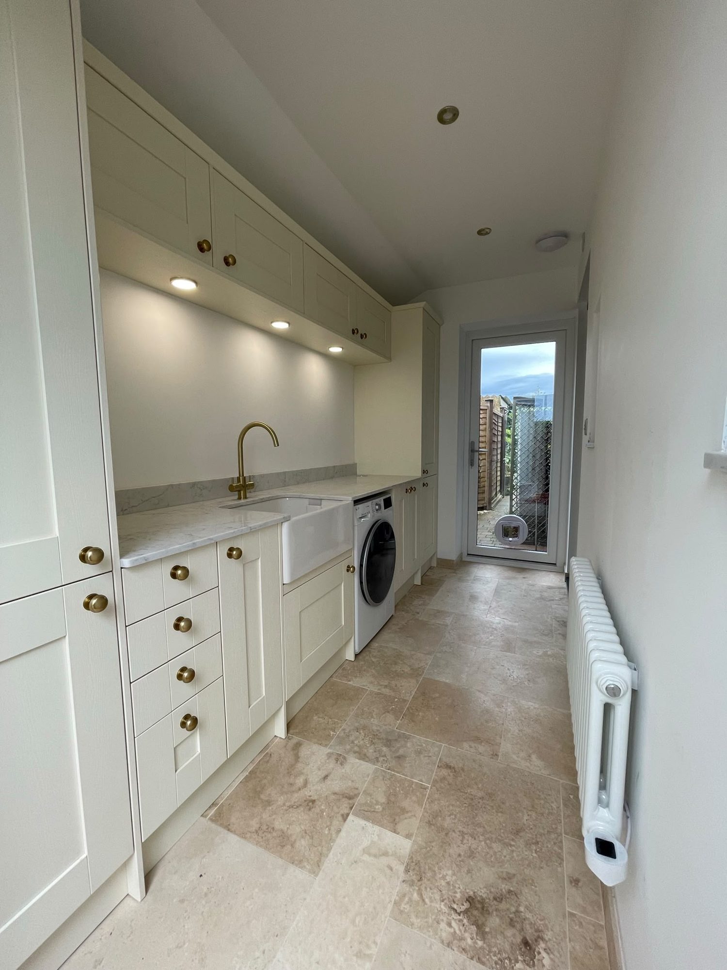 Renovated utility room with shaker units and stone floor in Northampton