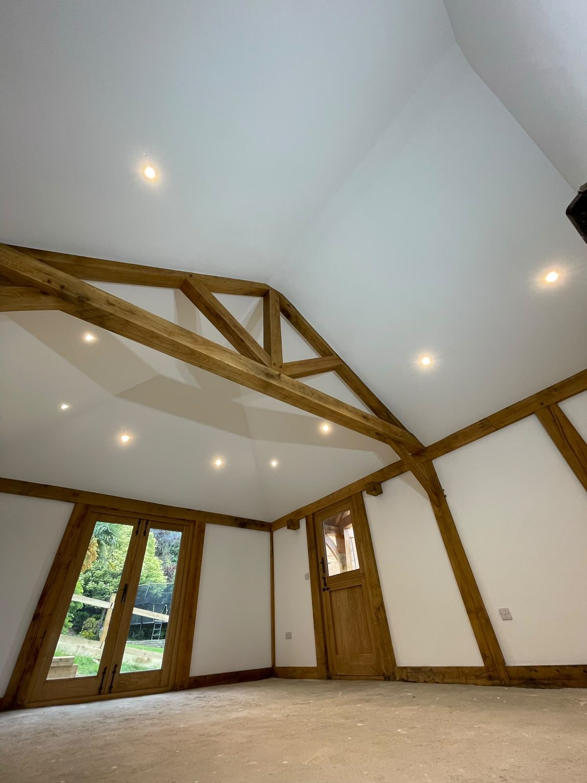 vaulted annex room with oak frame and French doors