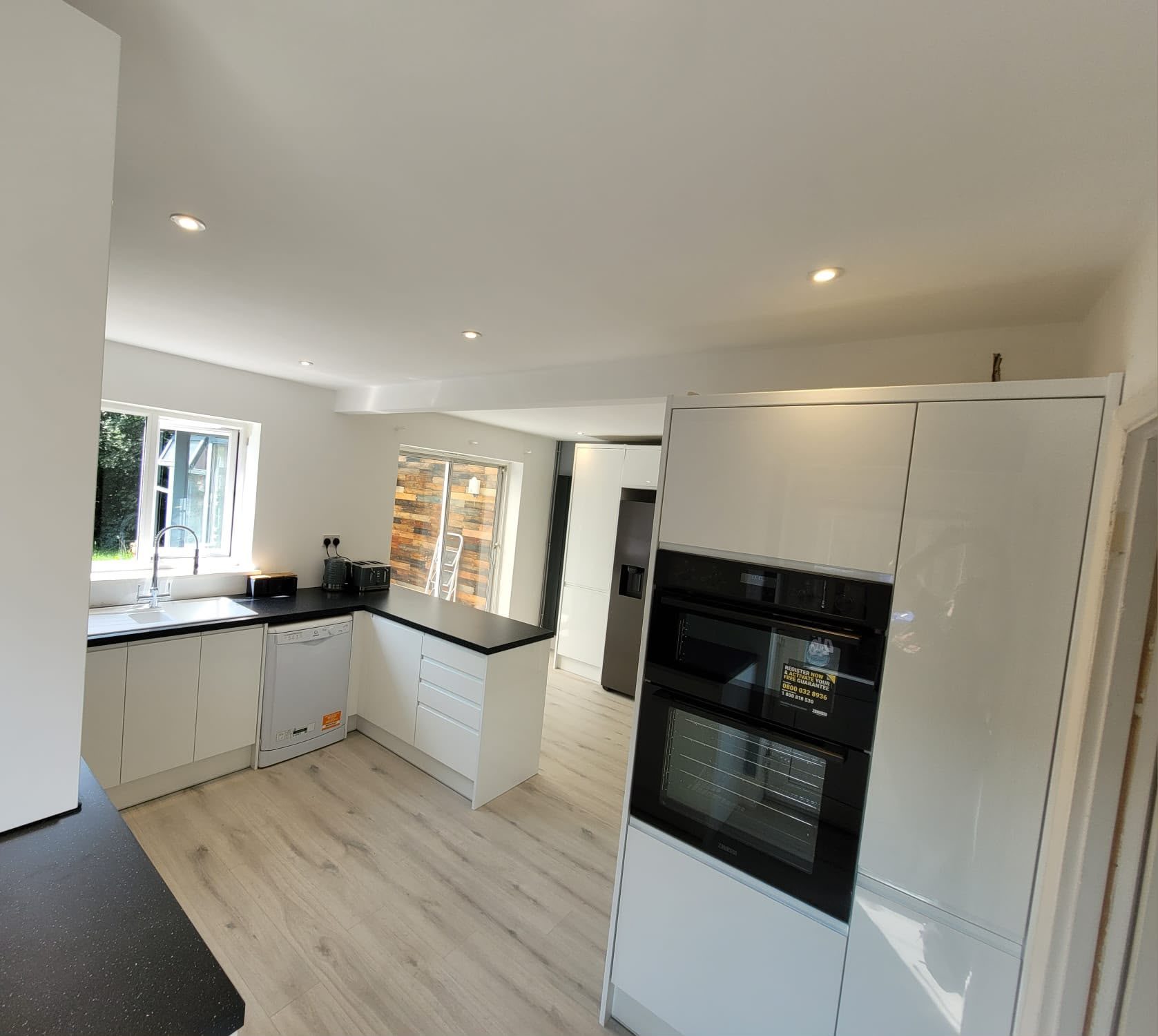 white kitchen with tall ovens