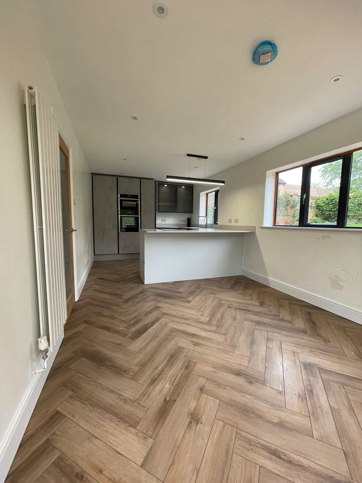 open-plan kitchen with herringbone floor
