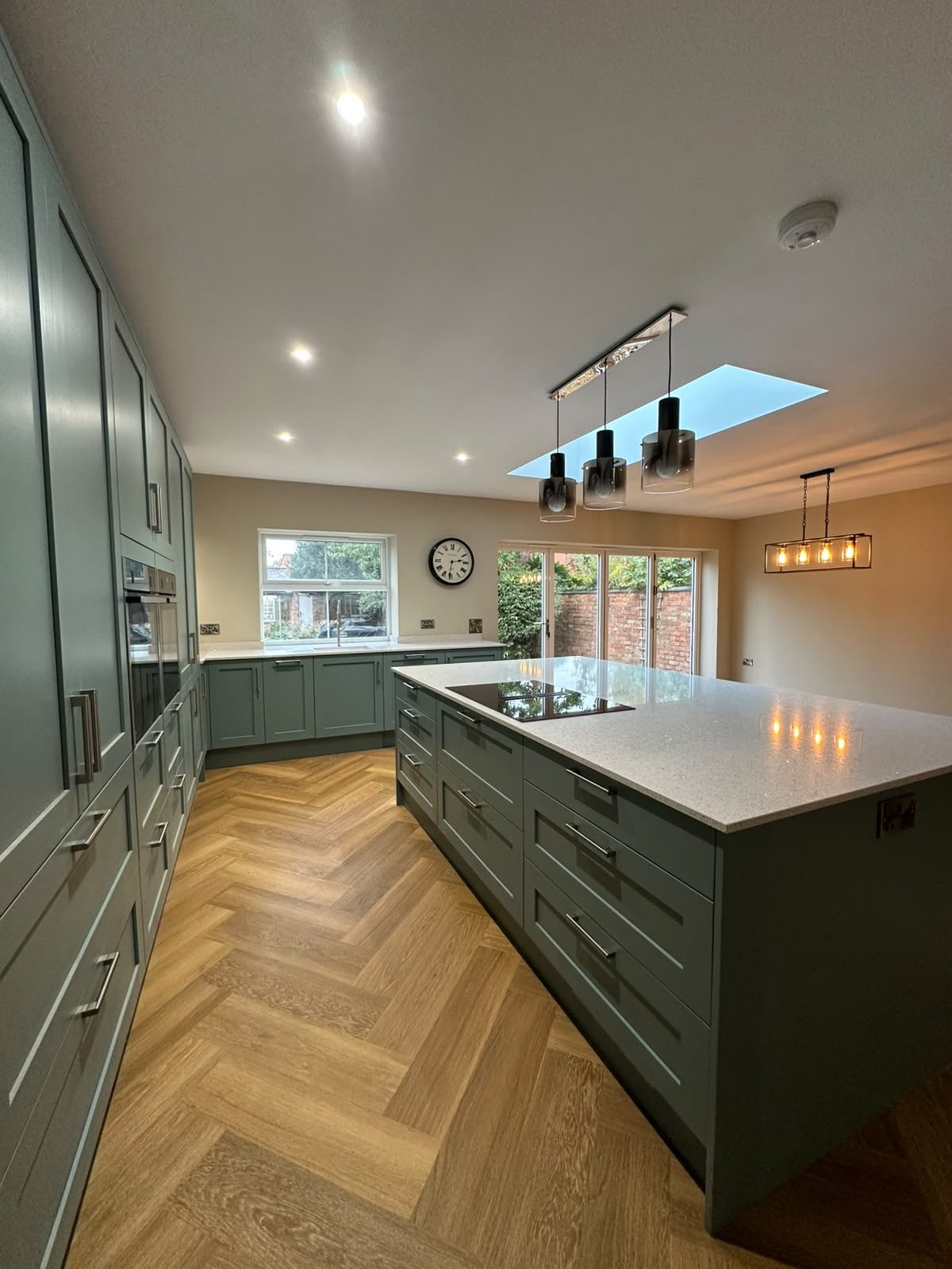 green shaker kitchen with island