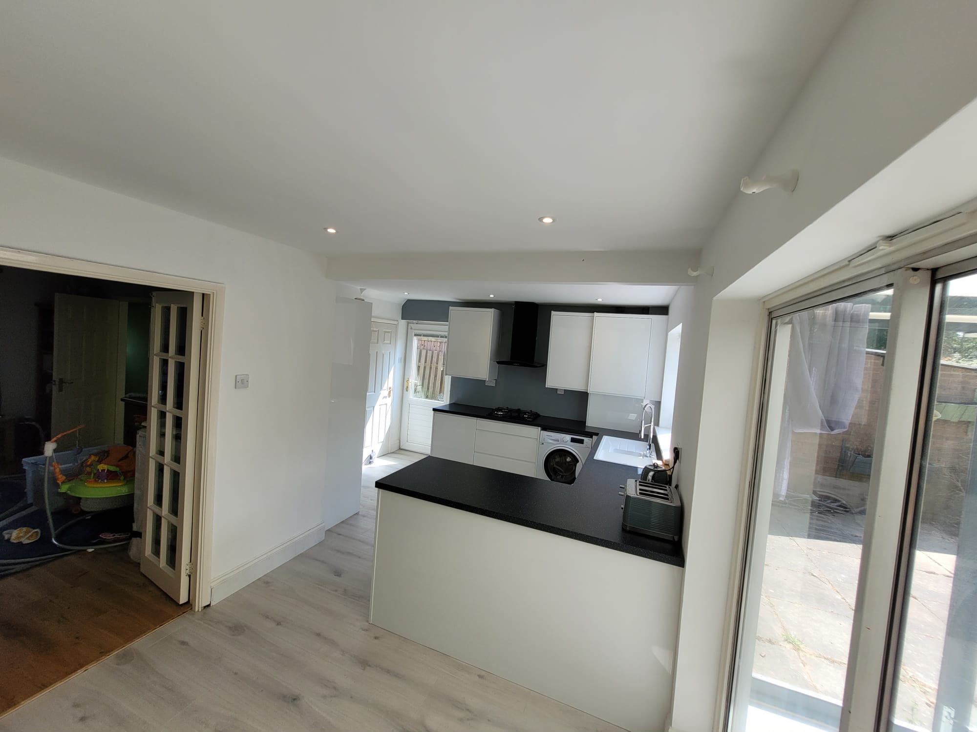 white kitchen with black worktops