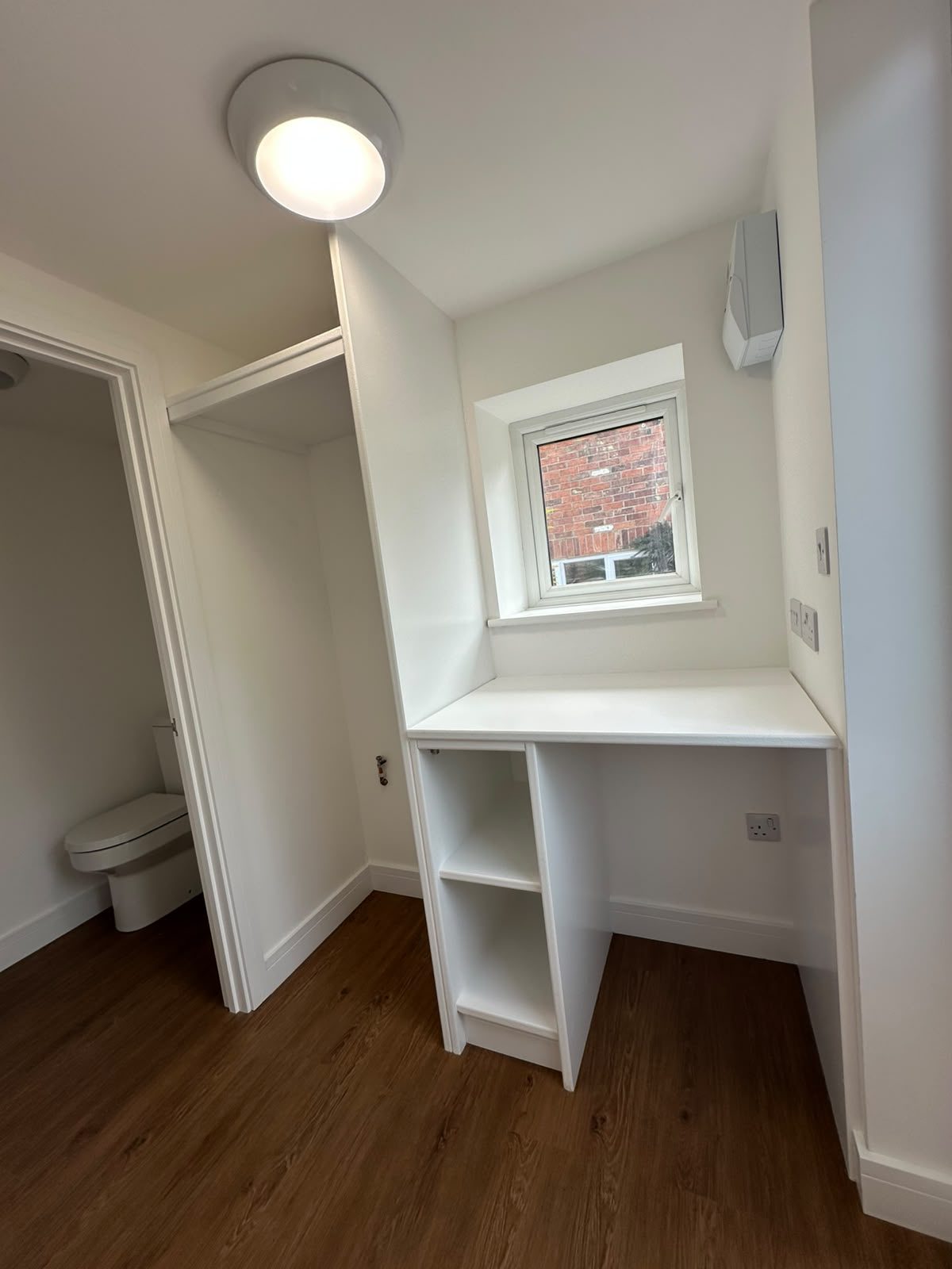 converted garage with built-in desk and storage