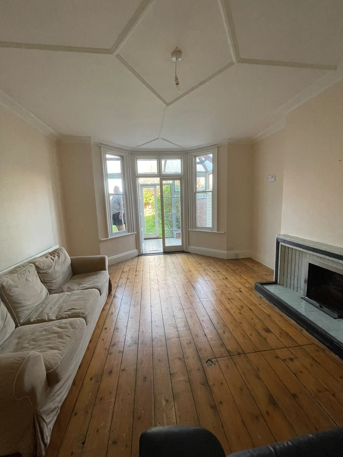 renovated bay-window lounge with wooden floor