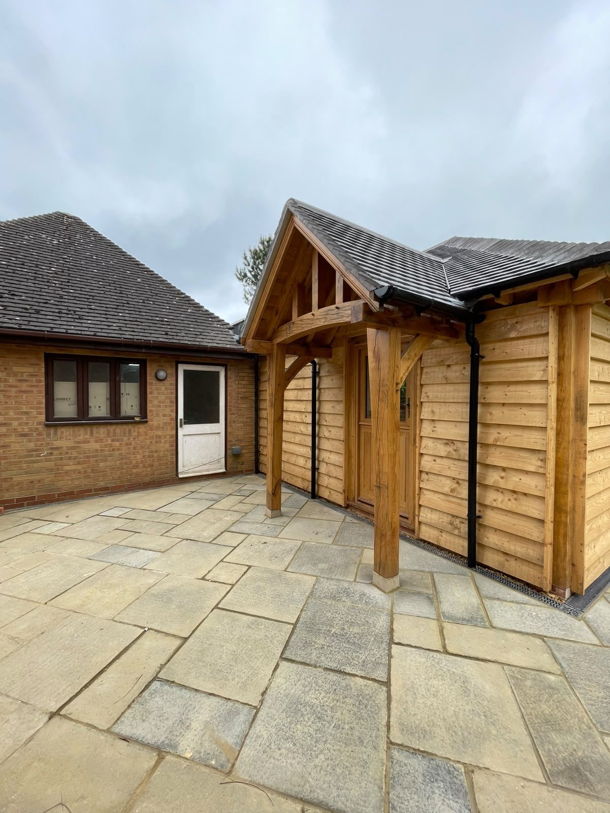 oak-framed garden annex with timber cladding and porch