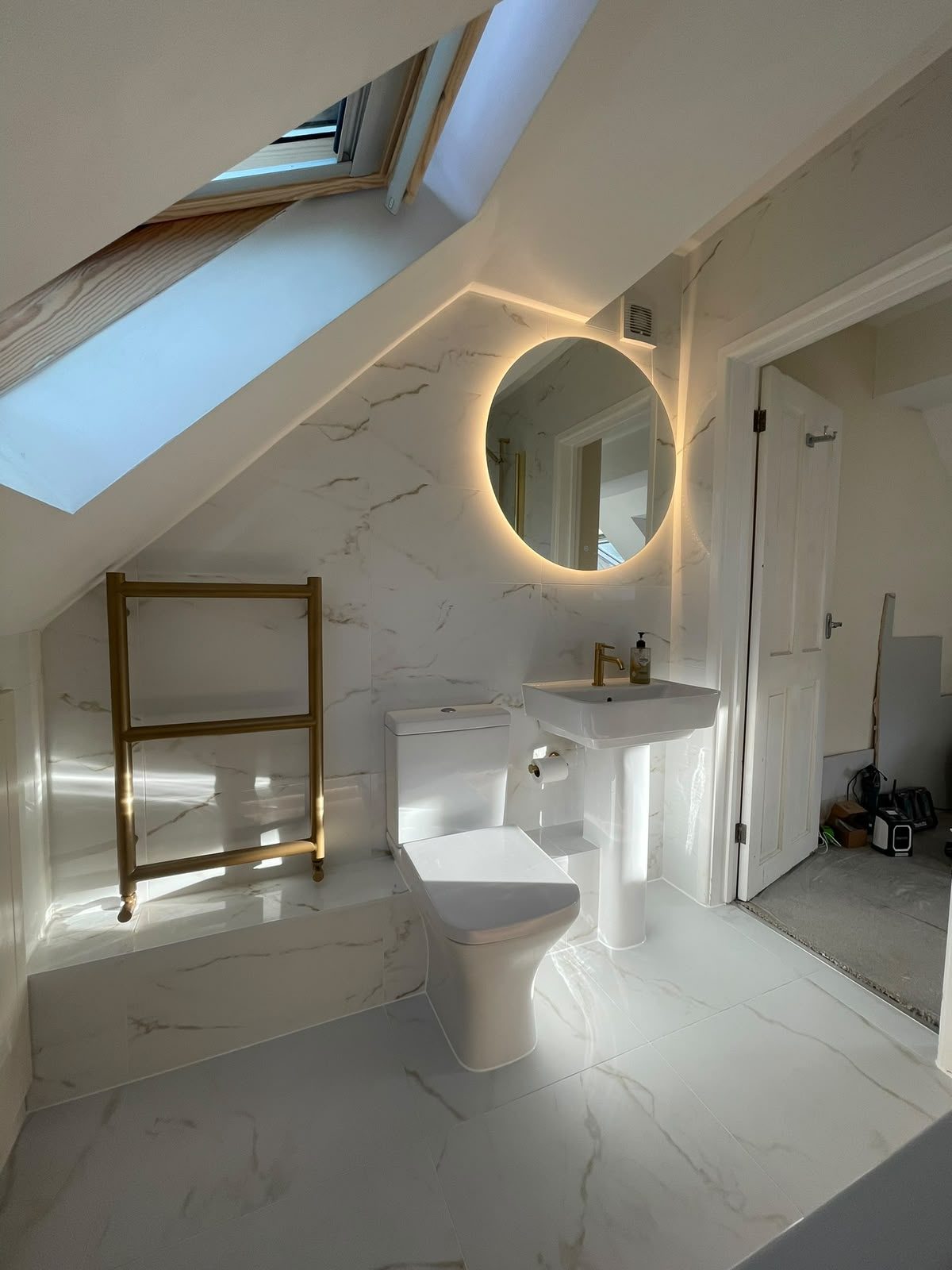 Loft conversion en suite with skylight and marble tiles in Northampton
