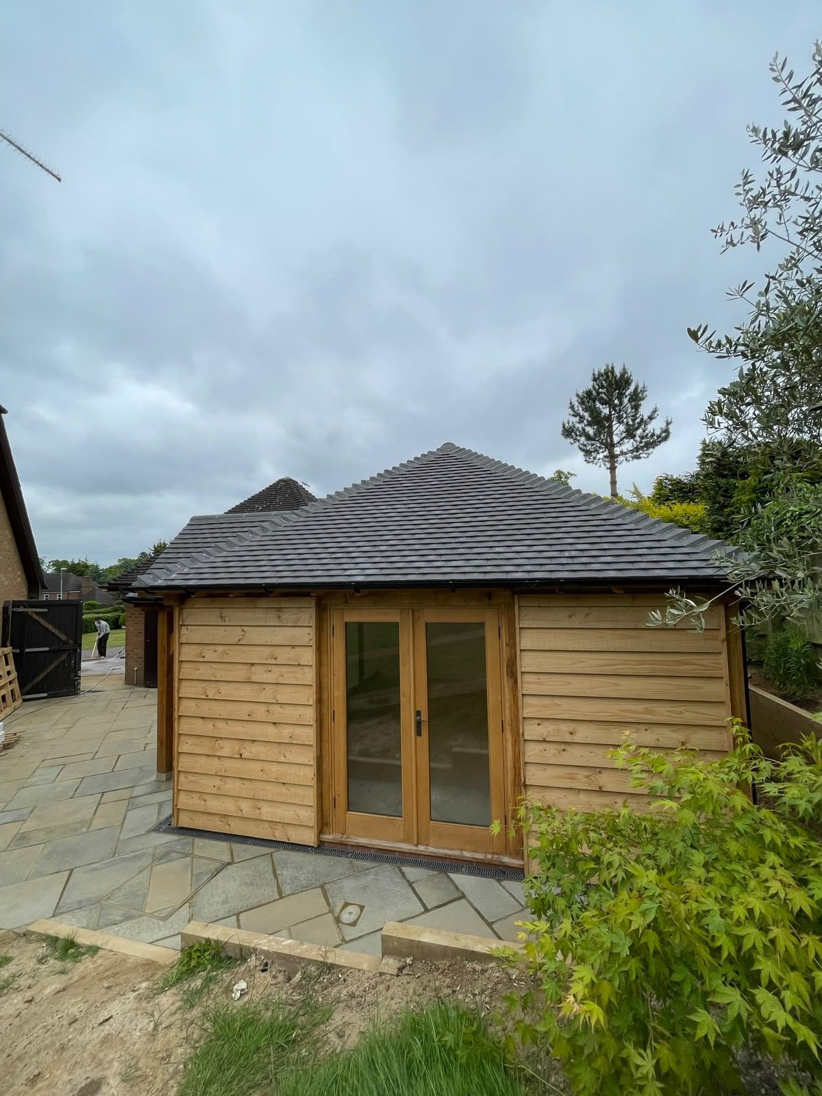 timber-clad garden annex with oak French doors