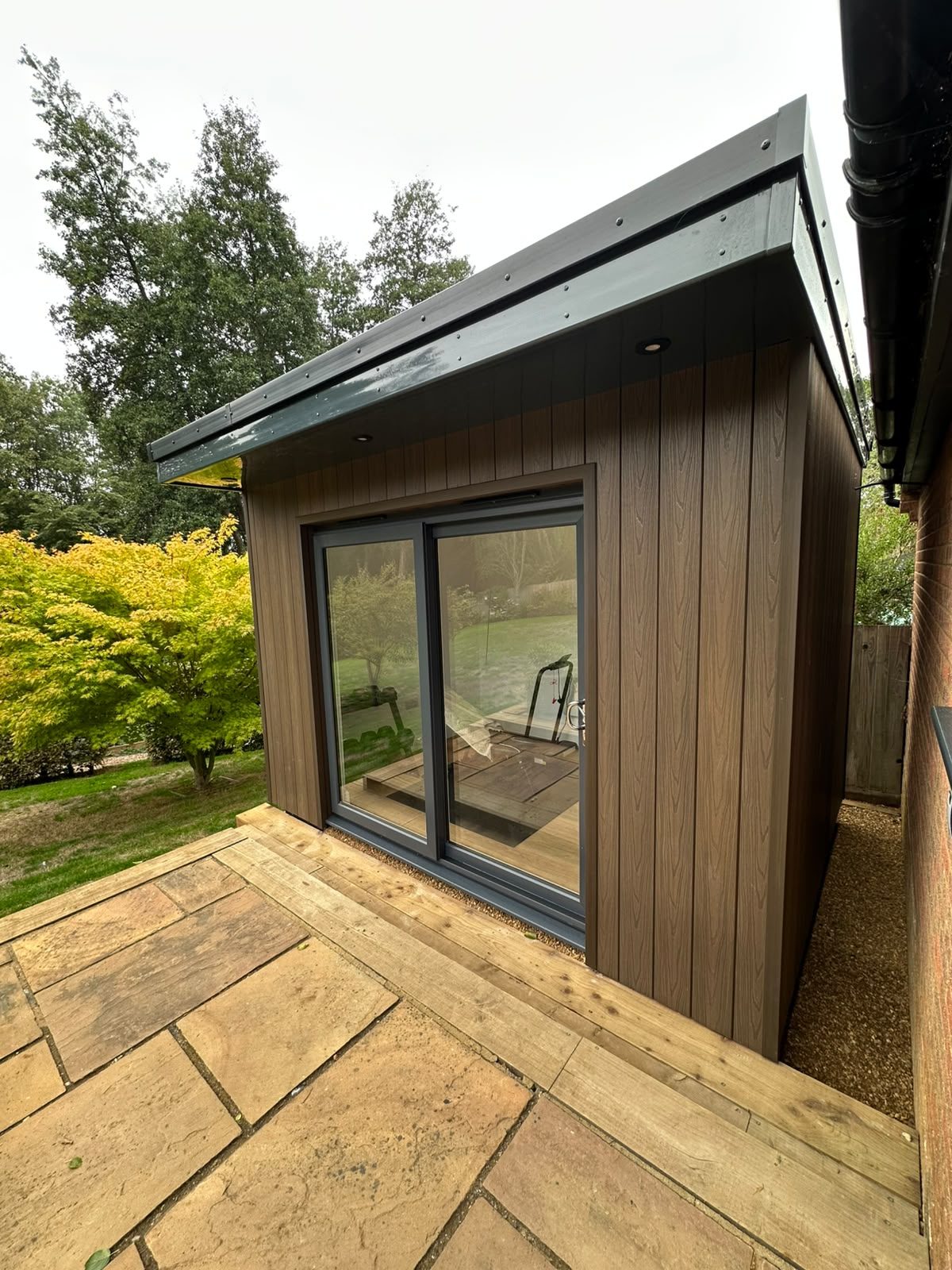 contemporary clad garden room with sliding doors