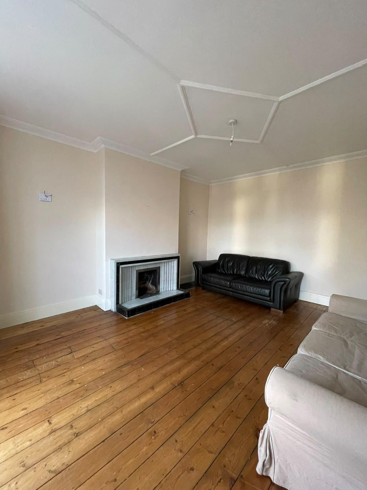 living room renovation with stripped floorboards