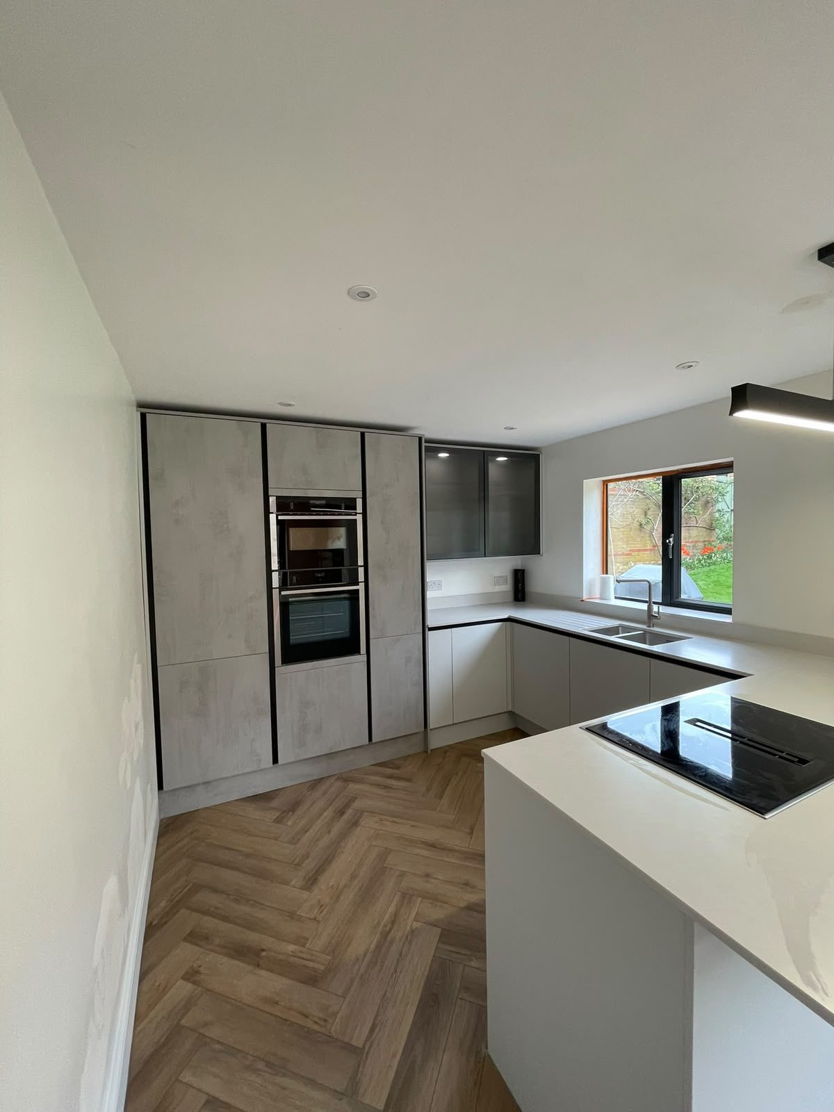 Reconfigured kitchen layout with herringbone floor in Northampton