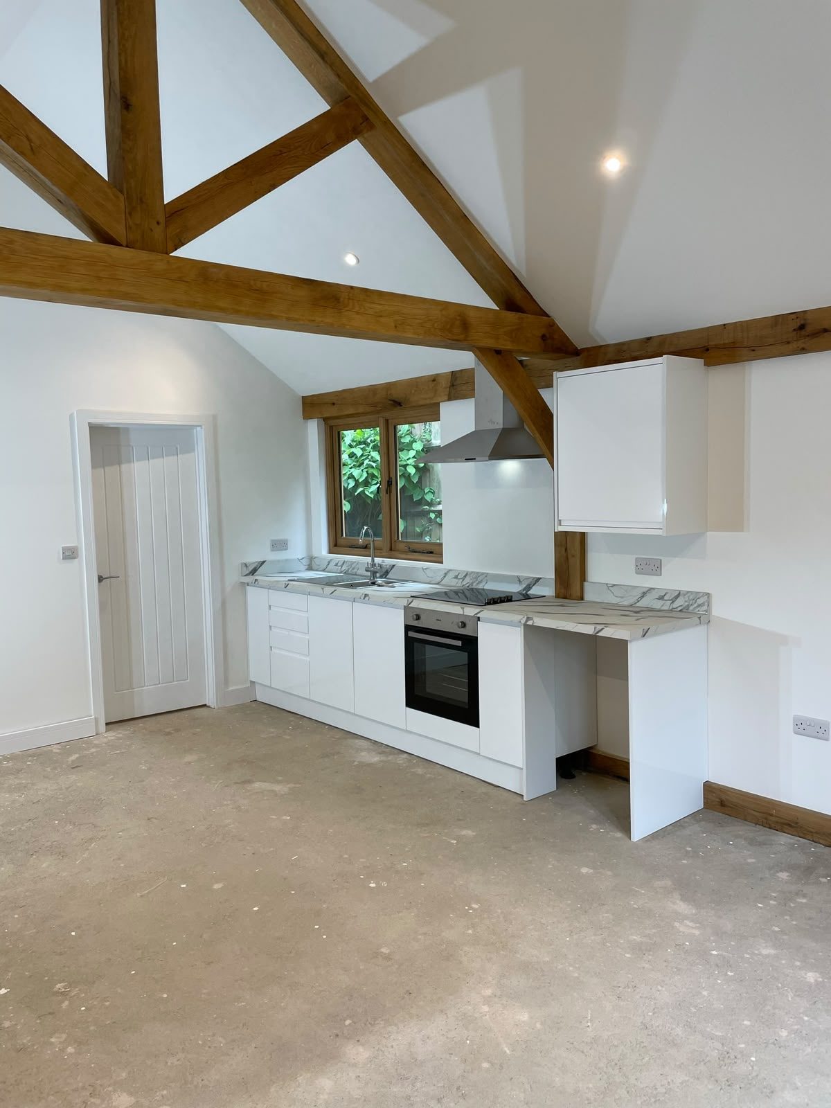 oak frame annex interior with vaulted ceiling and kitchenette